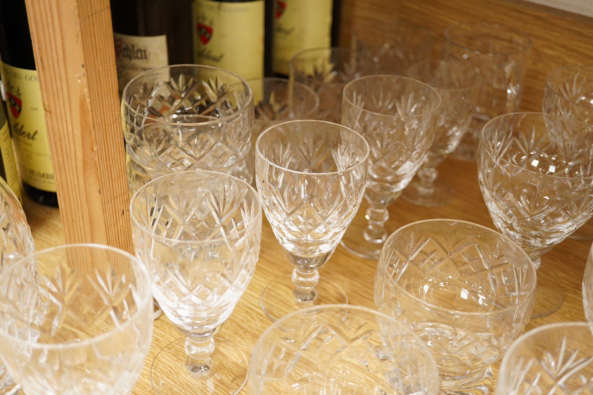 A collection of Webb cut glass suites and four decanters, together with a glass jug, largest 35cm high